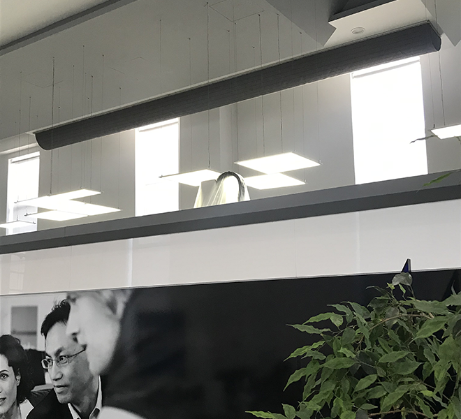 Black D-shape air duct inside an office, 2