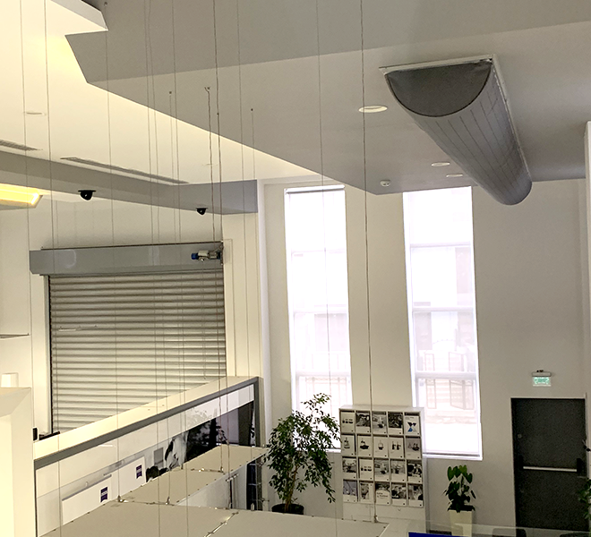 Grey duct system inside an office workspace, 2