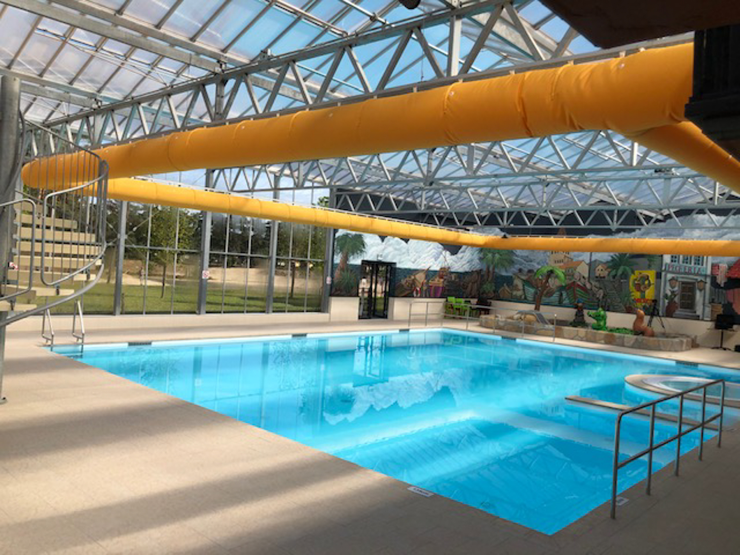 Orange air ducts installed inside an indoor swimming pool, CA