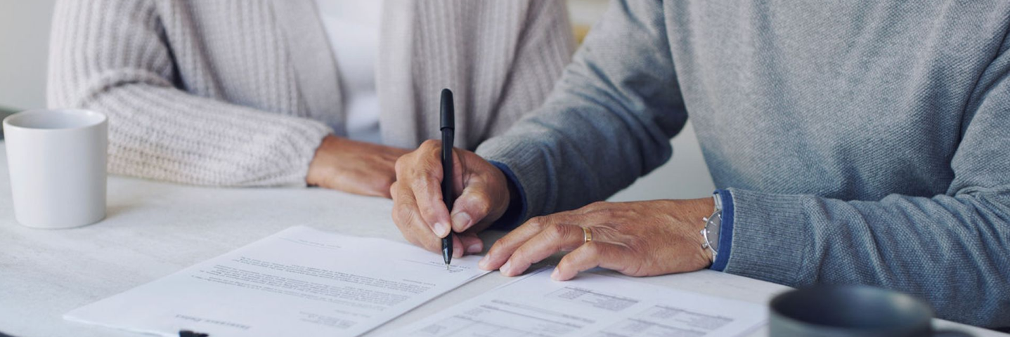 Man signing a warranty document, 2