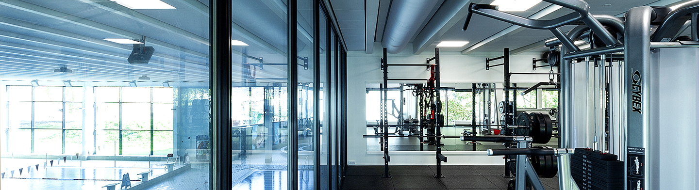 Grey duct systems inside a commercial gym, 2