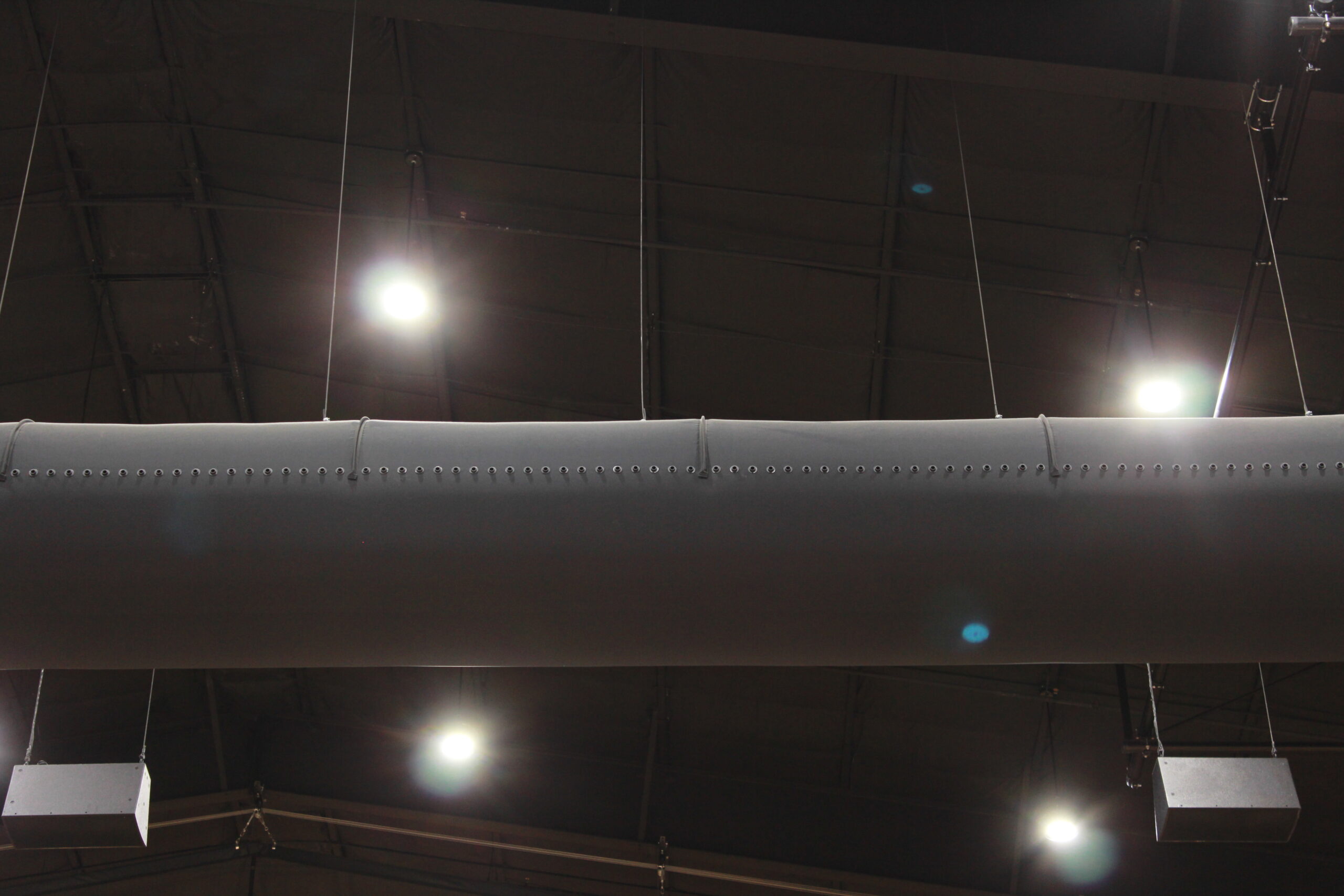 Black oval ductwork in Emmanuel College sport facility, USA, 2