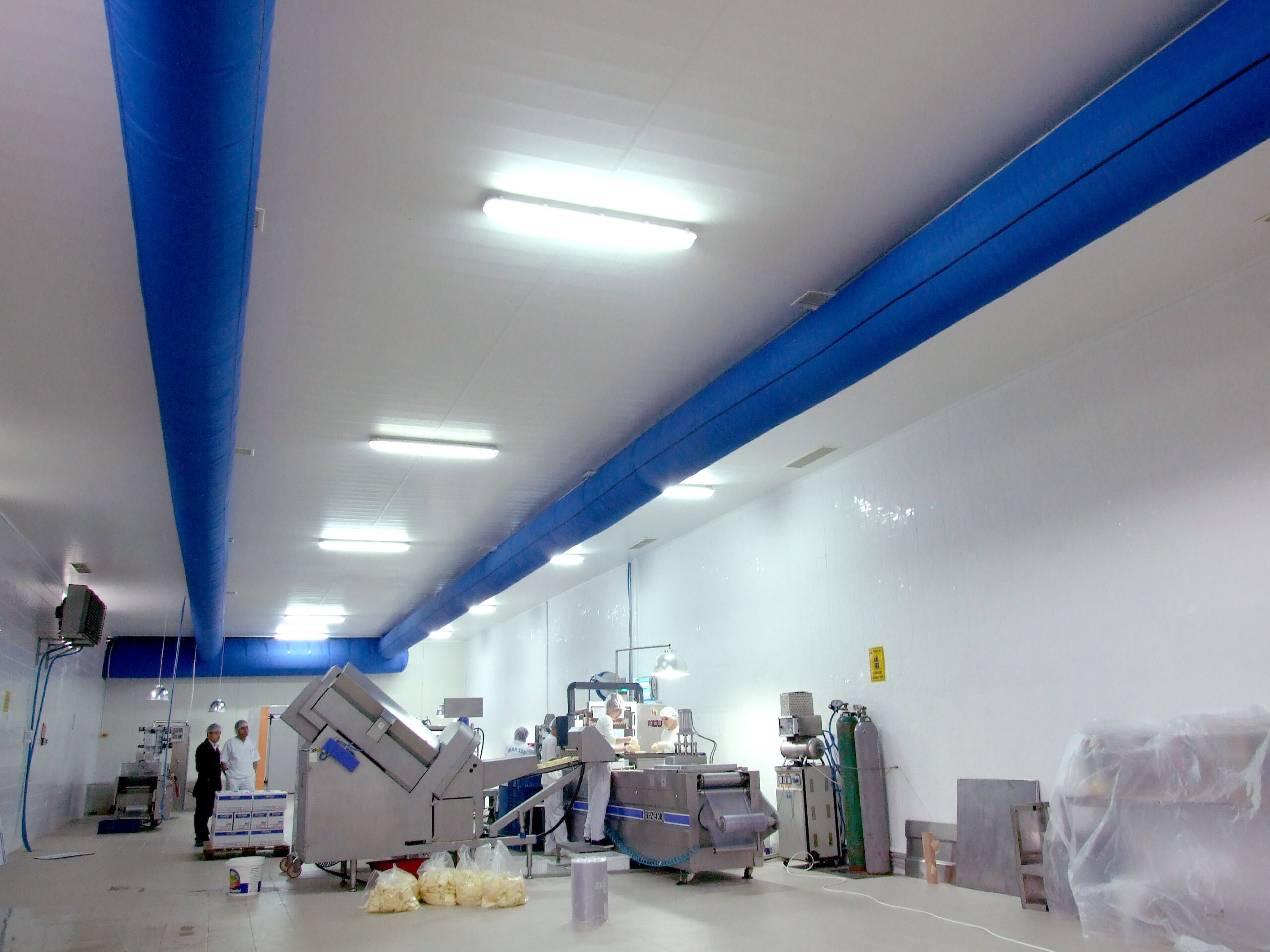 İnan Süt dairy processing factory interior with blue air ducts suspended on a ceiling, TR, 2