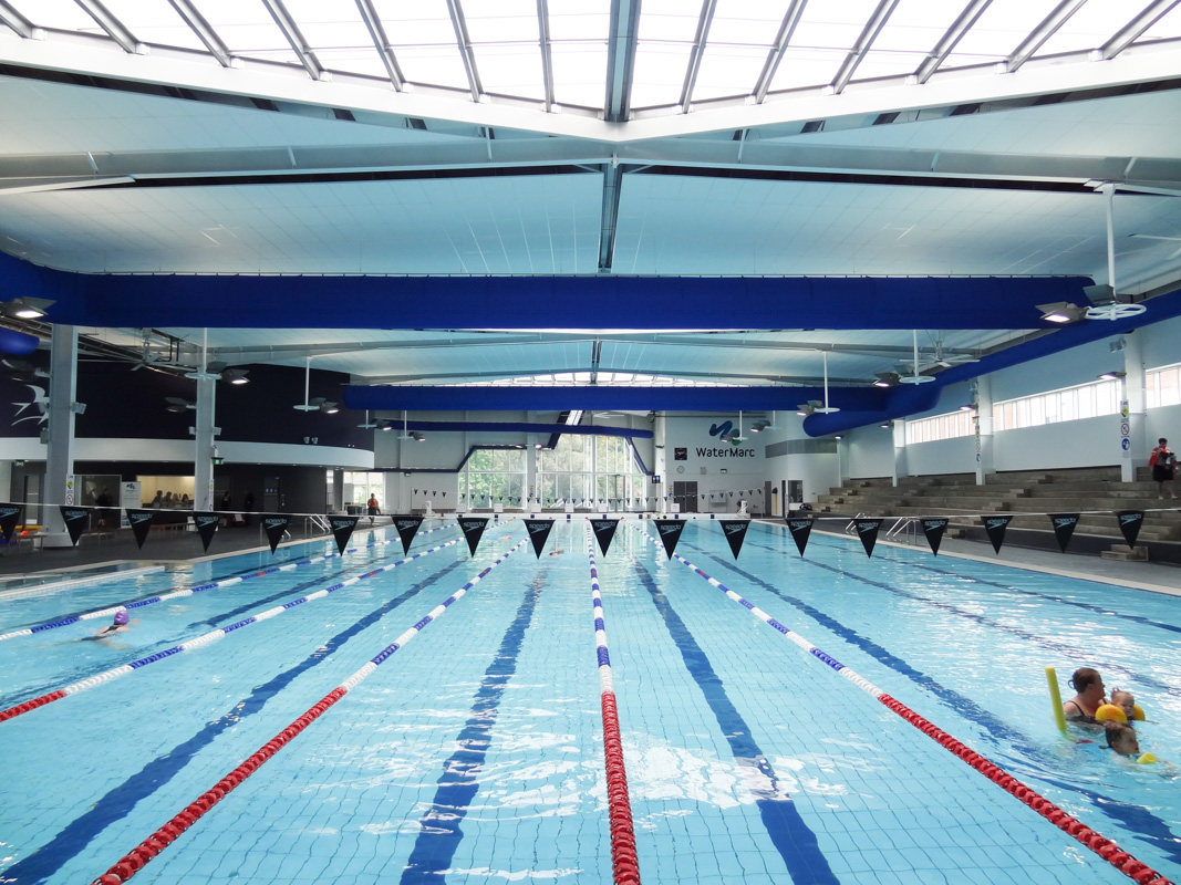 Blue oval ductwork in WaterMarc indoor swimming pool facilities, Australia
