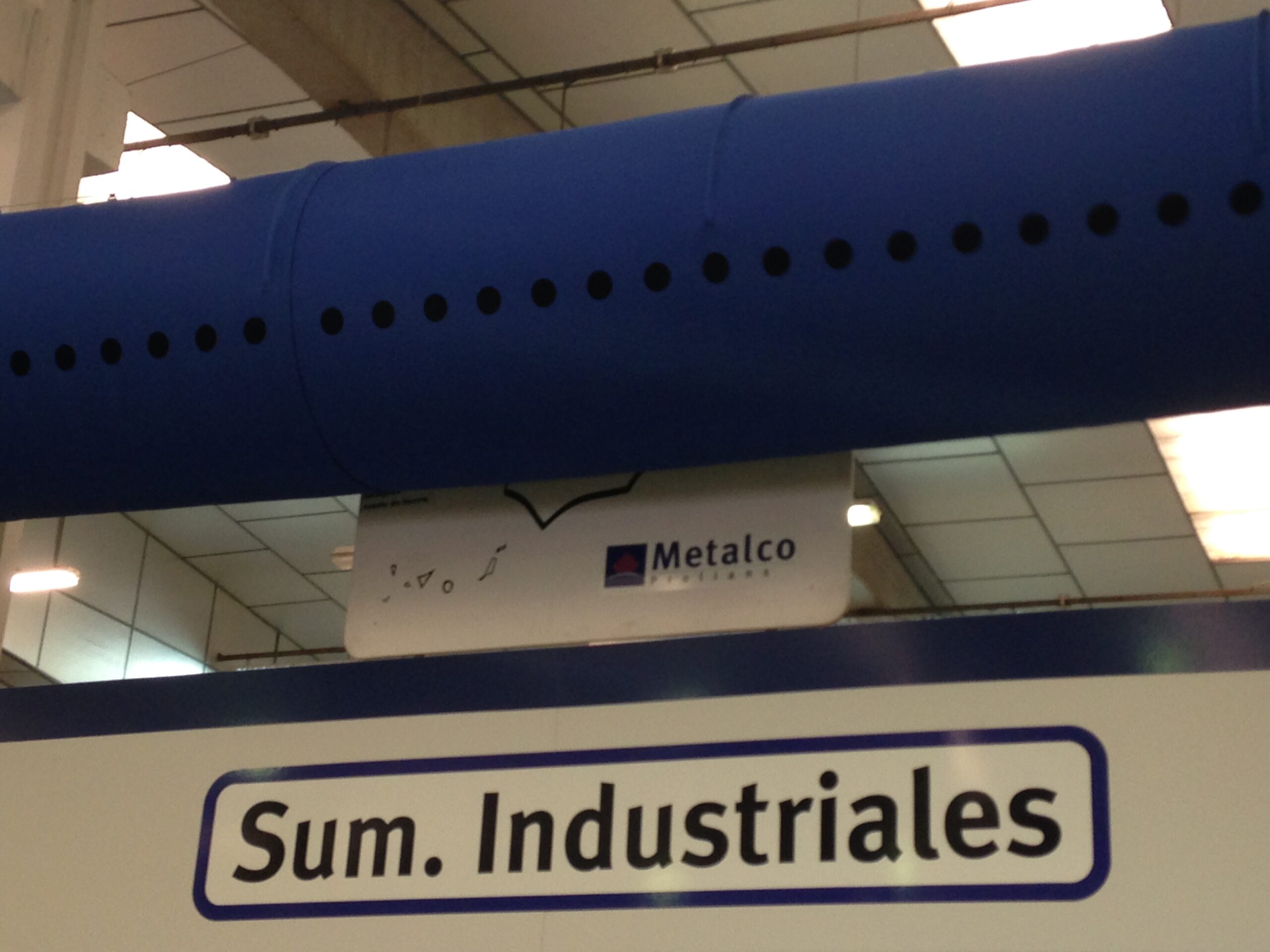 Blue, oval ductwork installed in Metalco store, Zaragoza, Spain, 2