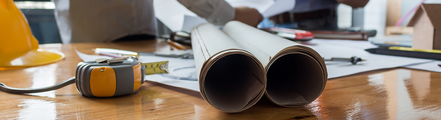 Architect working on blueprint in the office, 2
