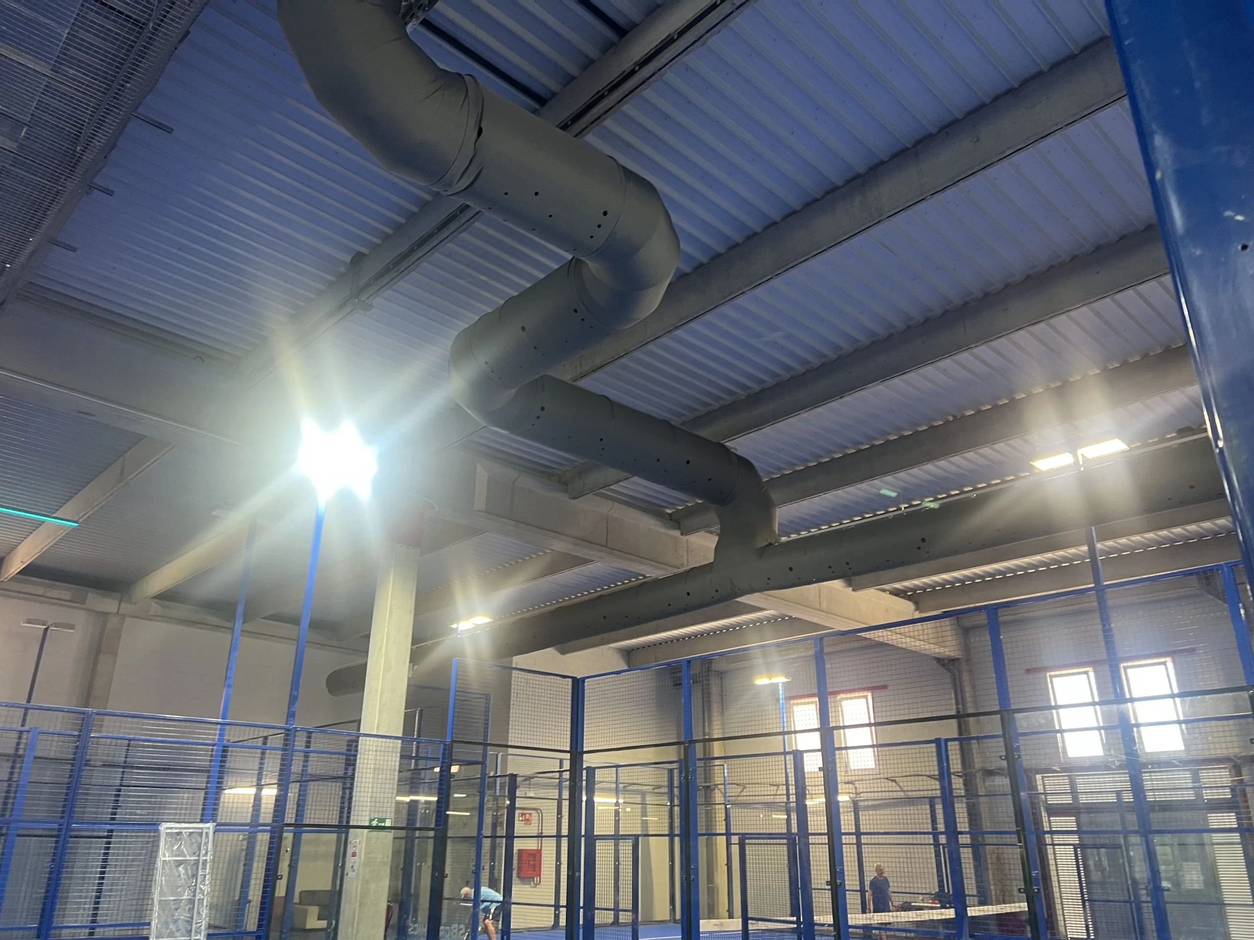 Black industrial duct systems inside a warehouse