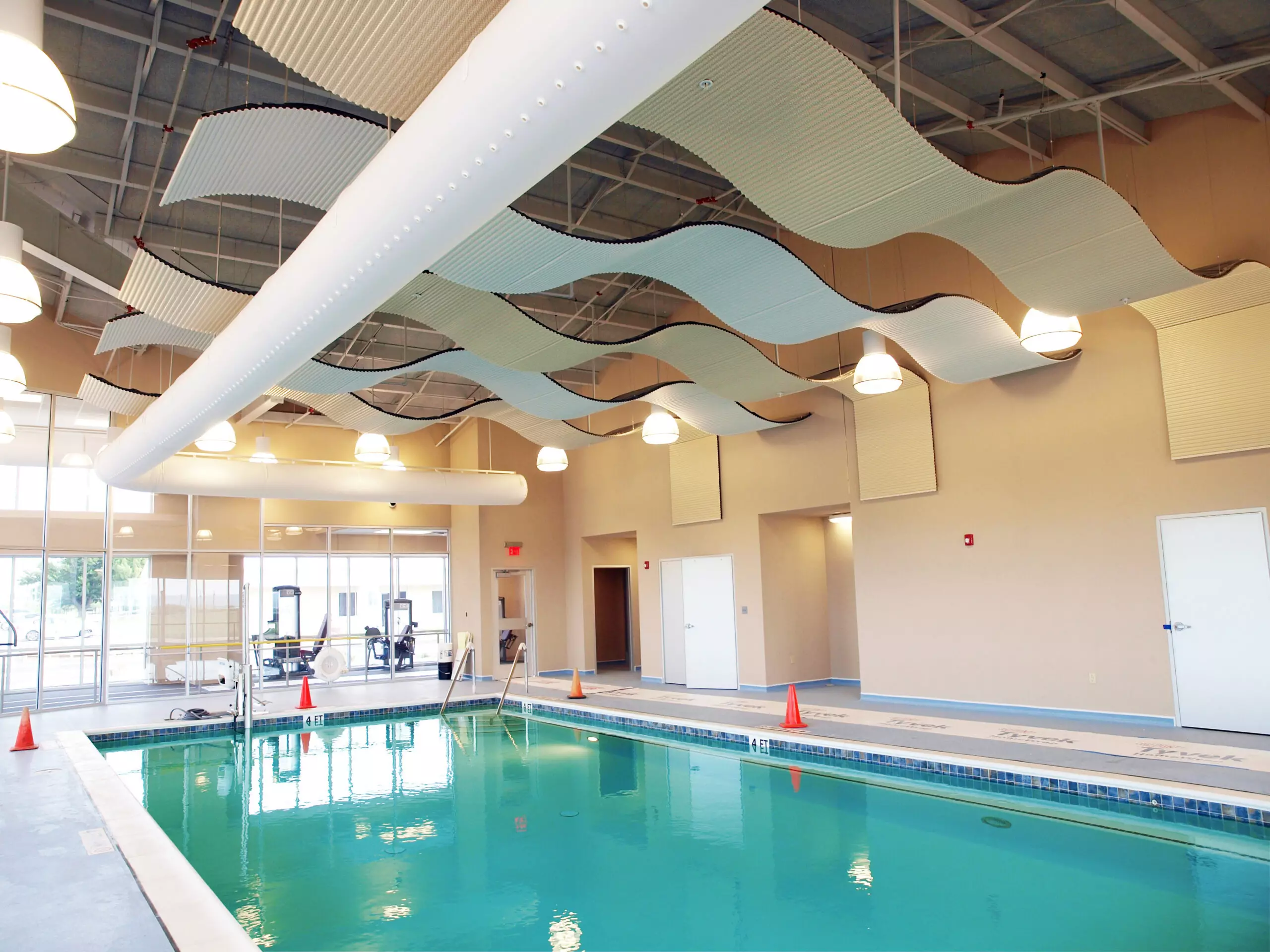 White oval ductwork inside an indoor swimming facility, CA