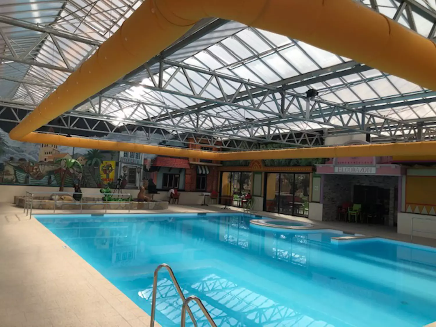Orange ducts for air conditioning inside a swimming pool facility, CA