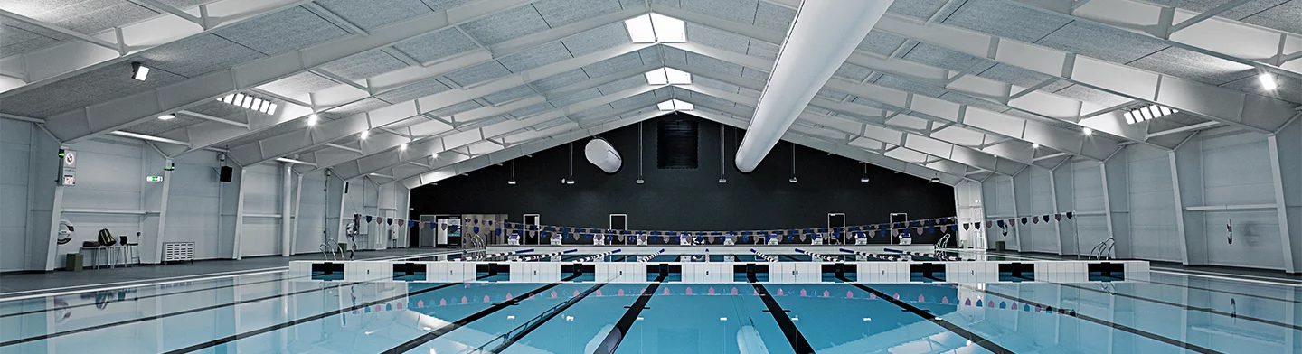White ducts for air conditioning inside a swimming pool facility, CA
