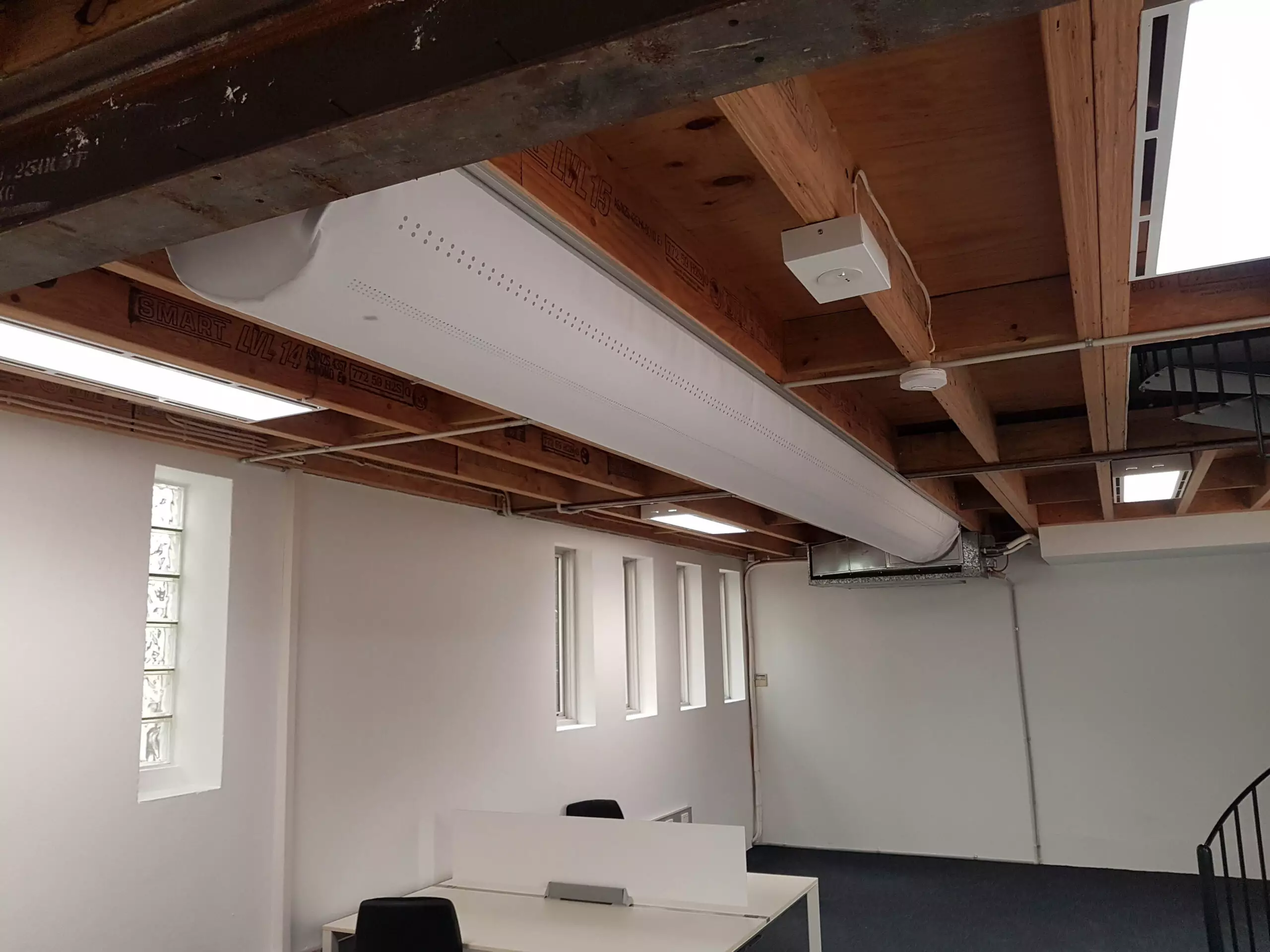 White oval ductwork inside an office, 2