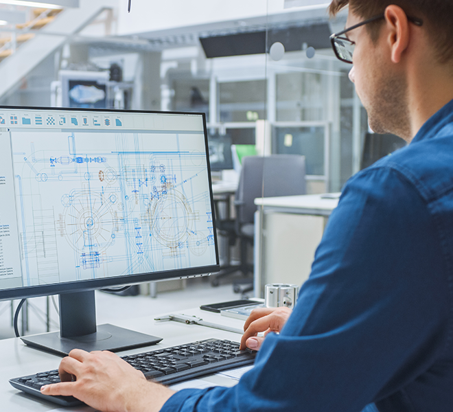 Man working on a computer inside an office, IN