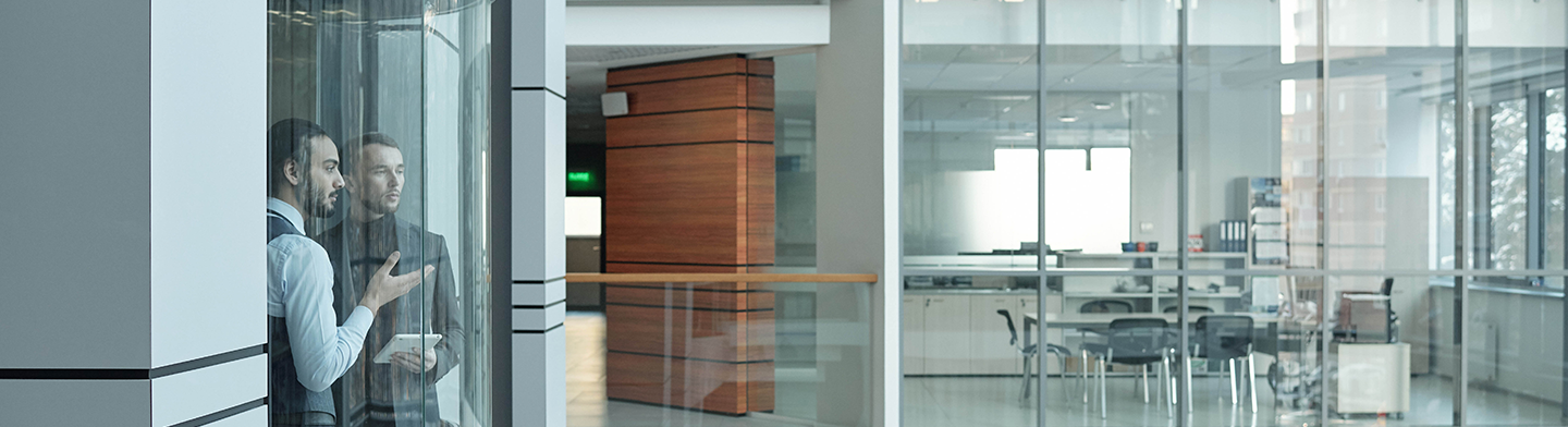 Colleagues discussing work inside a modern office, IN