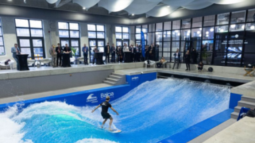 Gray fabric air ducting system provides ventilation for innovative citywave indoor surfing facility in Lithuania