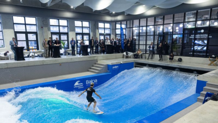 Gray fabric air ducting system provides ventilation for innovative citywave indoor surfing facility in Lithuania