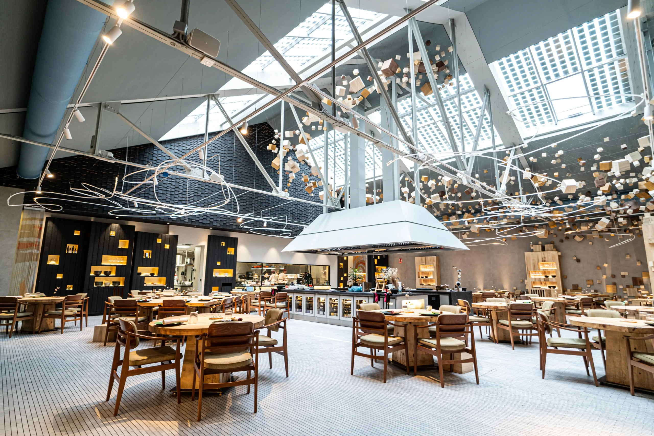 Gray fabric ducts installed in the dining room of Omeraki, a Michelin starred restaurant in Madrid.