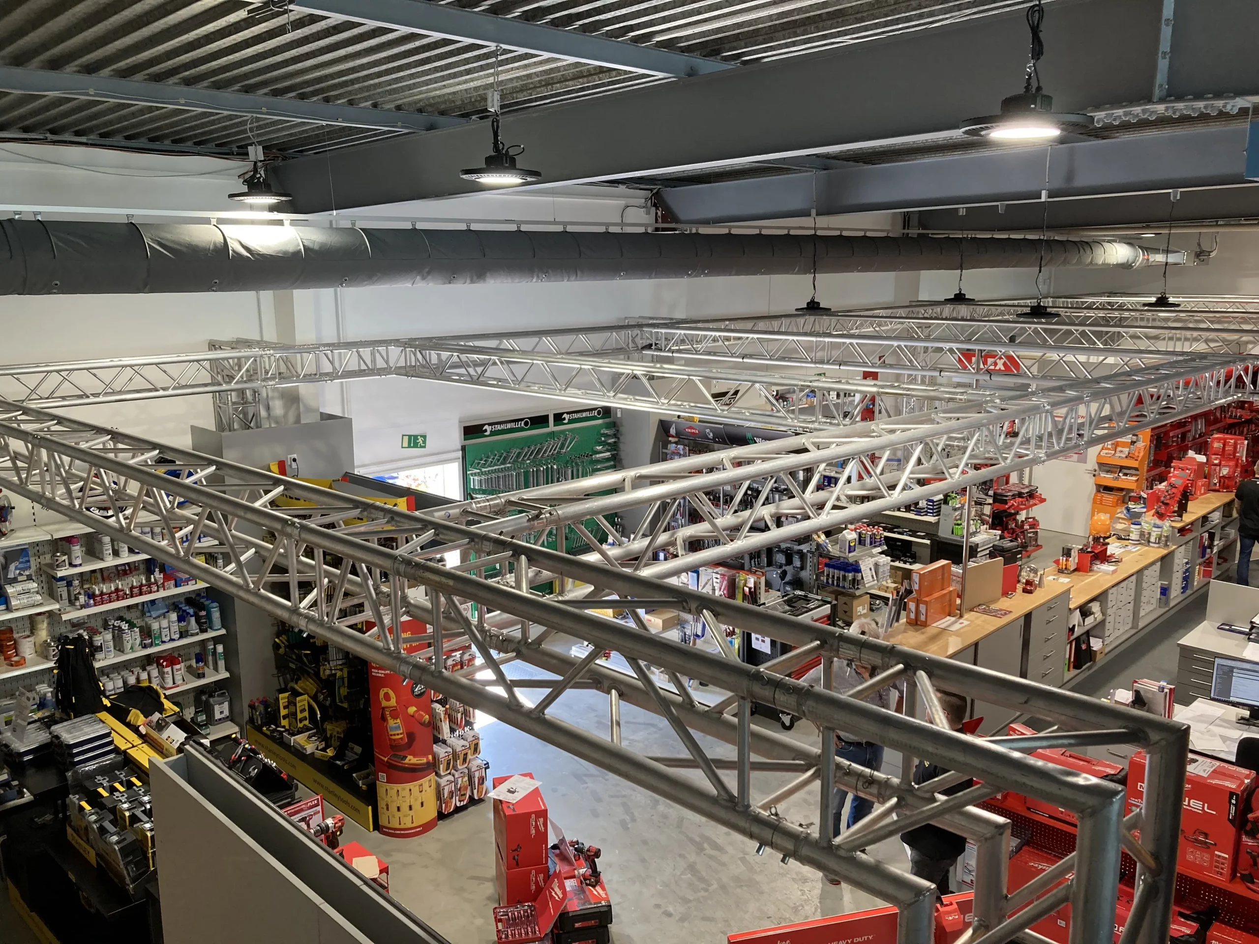 FabricAir’s Varioduct fabric duct solution is shown in the SWD A. Hock sales room in dark gray featuring nozzles and laser cut perforations precisely designed for temperature control that elevates indoor air quality in areas that require heating and cooling solutions.