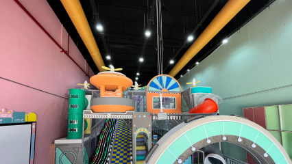 Orange FabricAir ducts provide safe, comfortable airflow for a trampoline park for children in Mumbai.