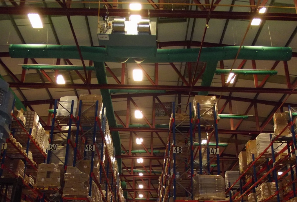 Industrial air duct systems with green fabric ducts installed in a storage center, Ireland, 2