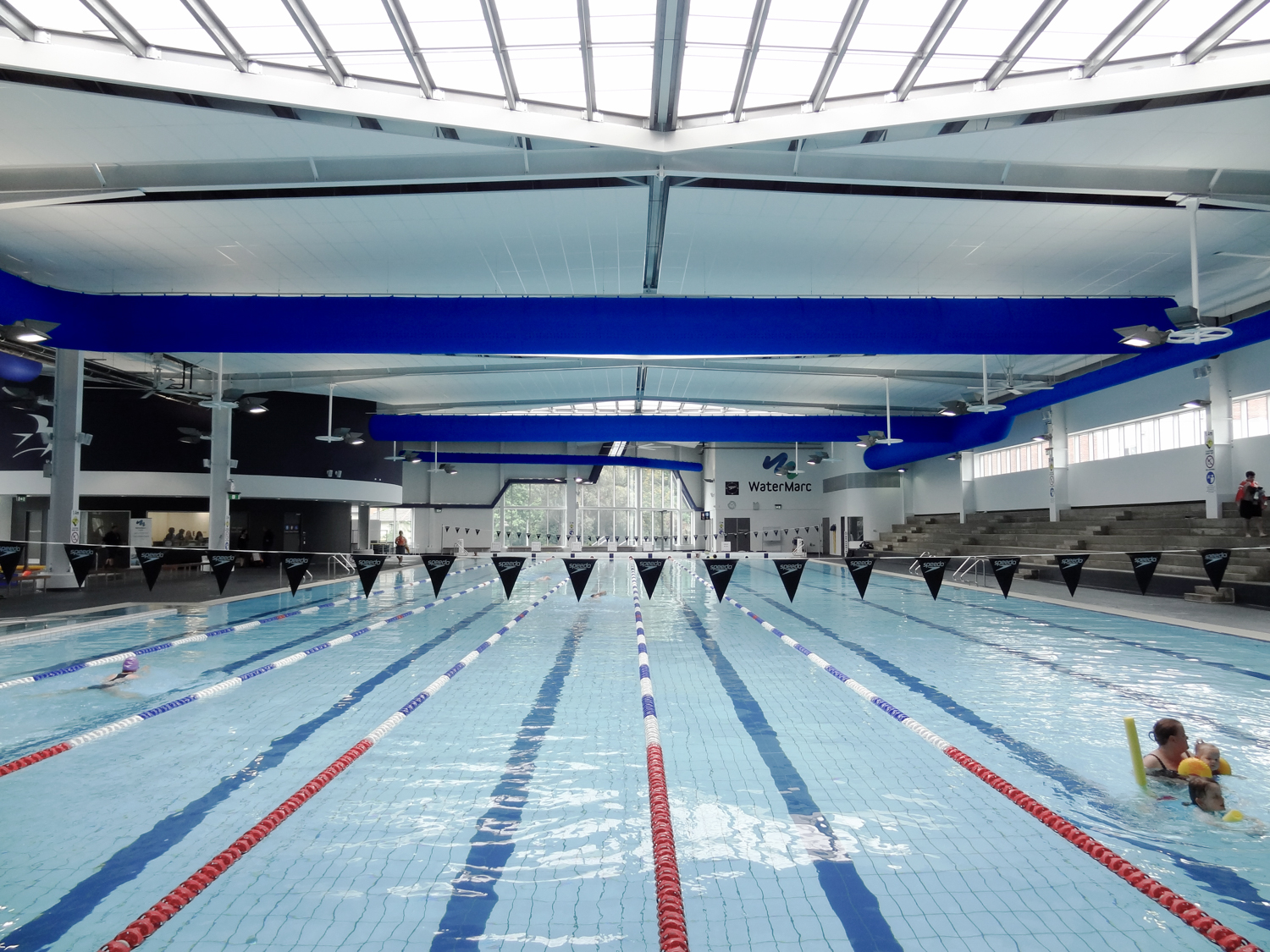 Blue fabric ducts installed inside WaterMark swimming pool facility in Greensborough, Australia, 2