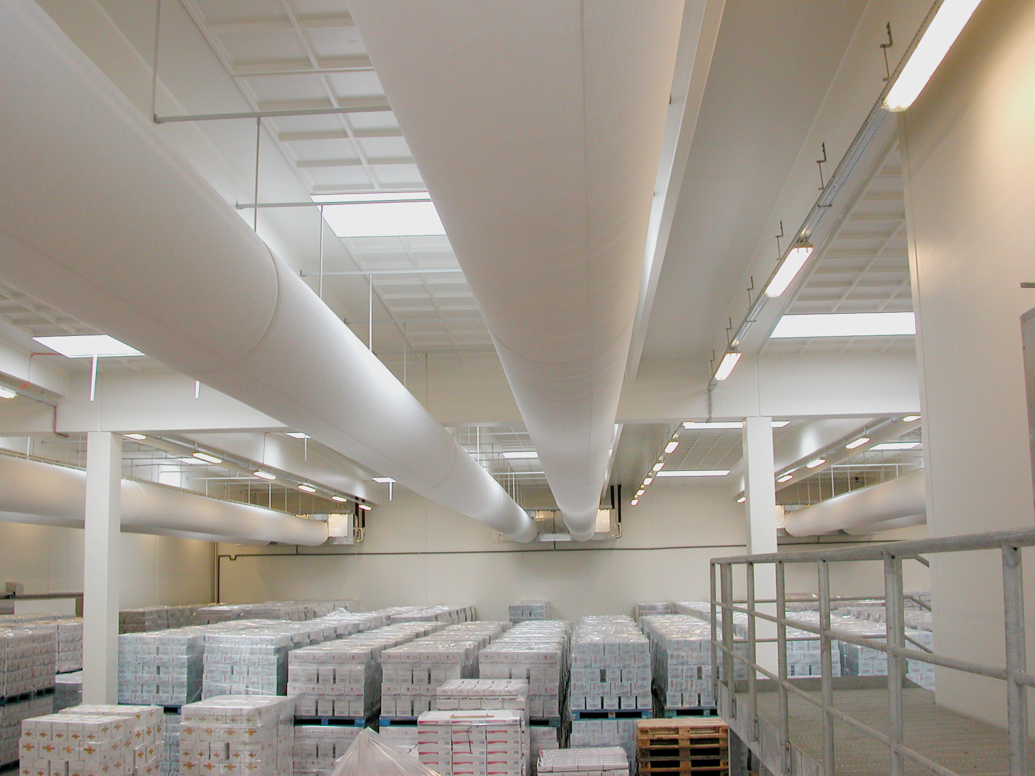 Industrial air duct systems with white ventilation ducts installed in Arla Food warehouse, Holstebro, Denmark, 2