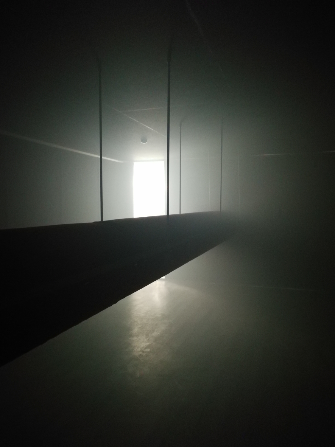 Black air duct system, also called a ductwork system, inside a dark and empty room, UK, 2