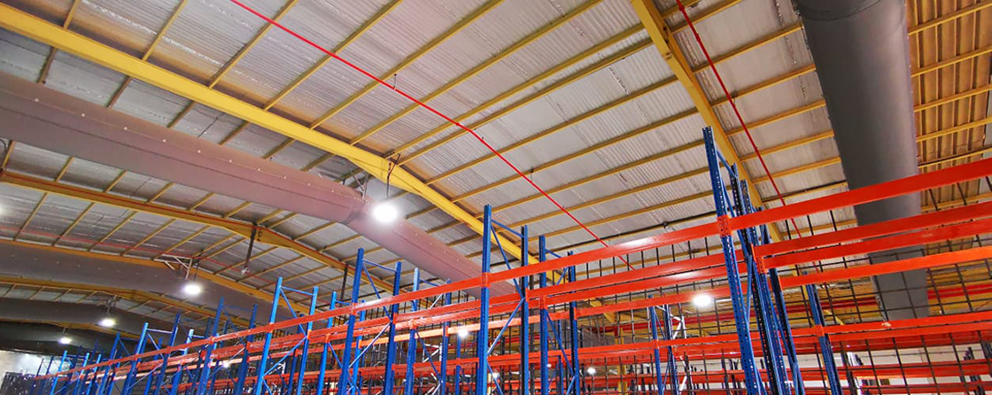 Storage warehouse ventilation system with grey fabric ducts, UK, 2