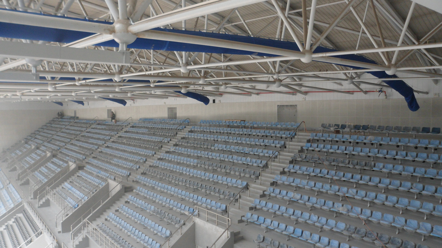 Swimming pool air duct systems with blue air duct design in DaLian Swimming Center, China, 2