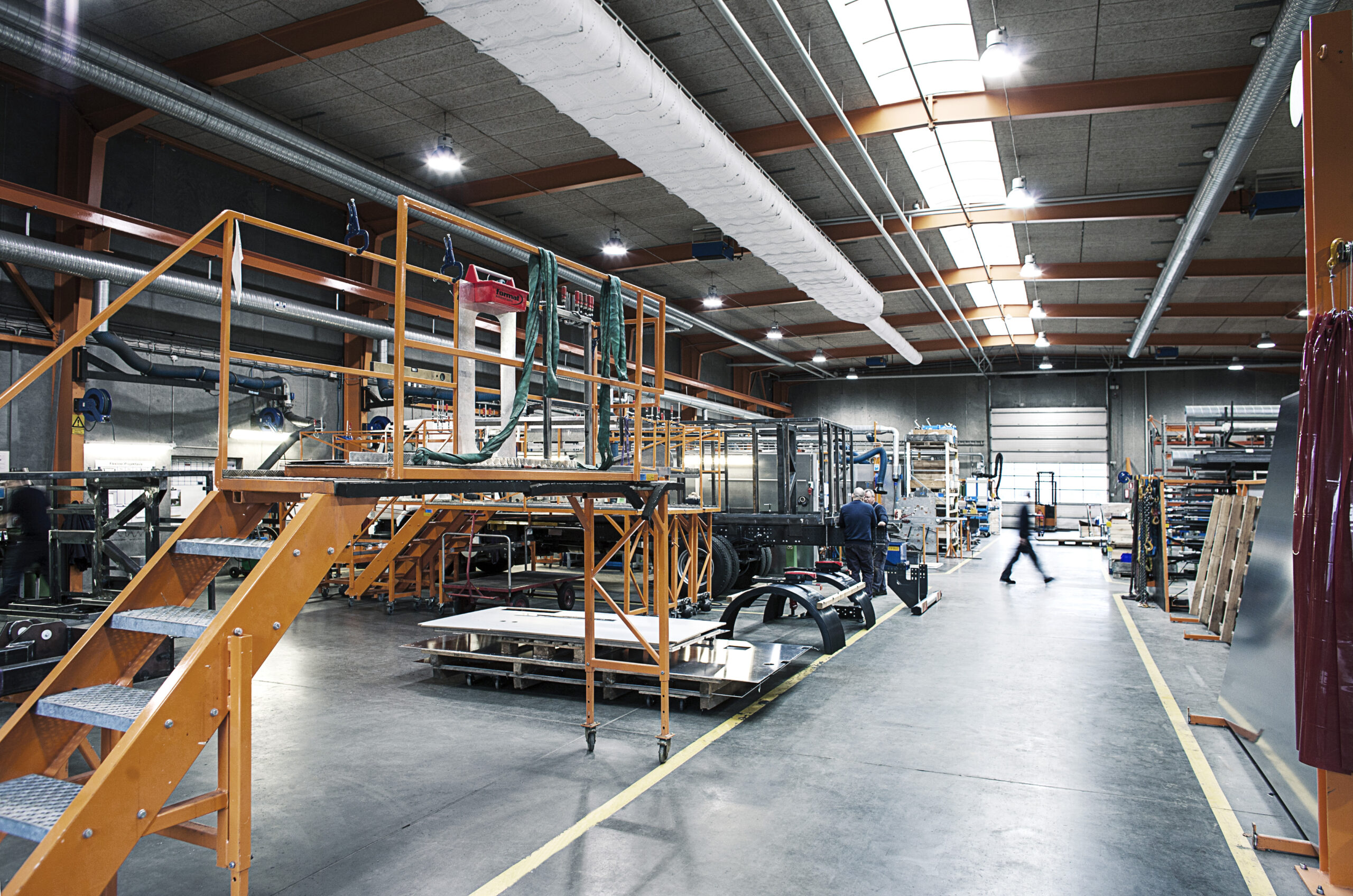 Industrial use air duct systems with white fabric duct design installed in Vestergaard Industries factory, Denmark, 2