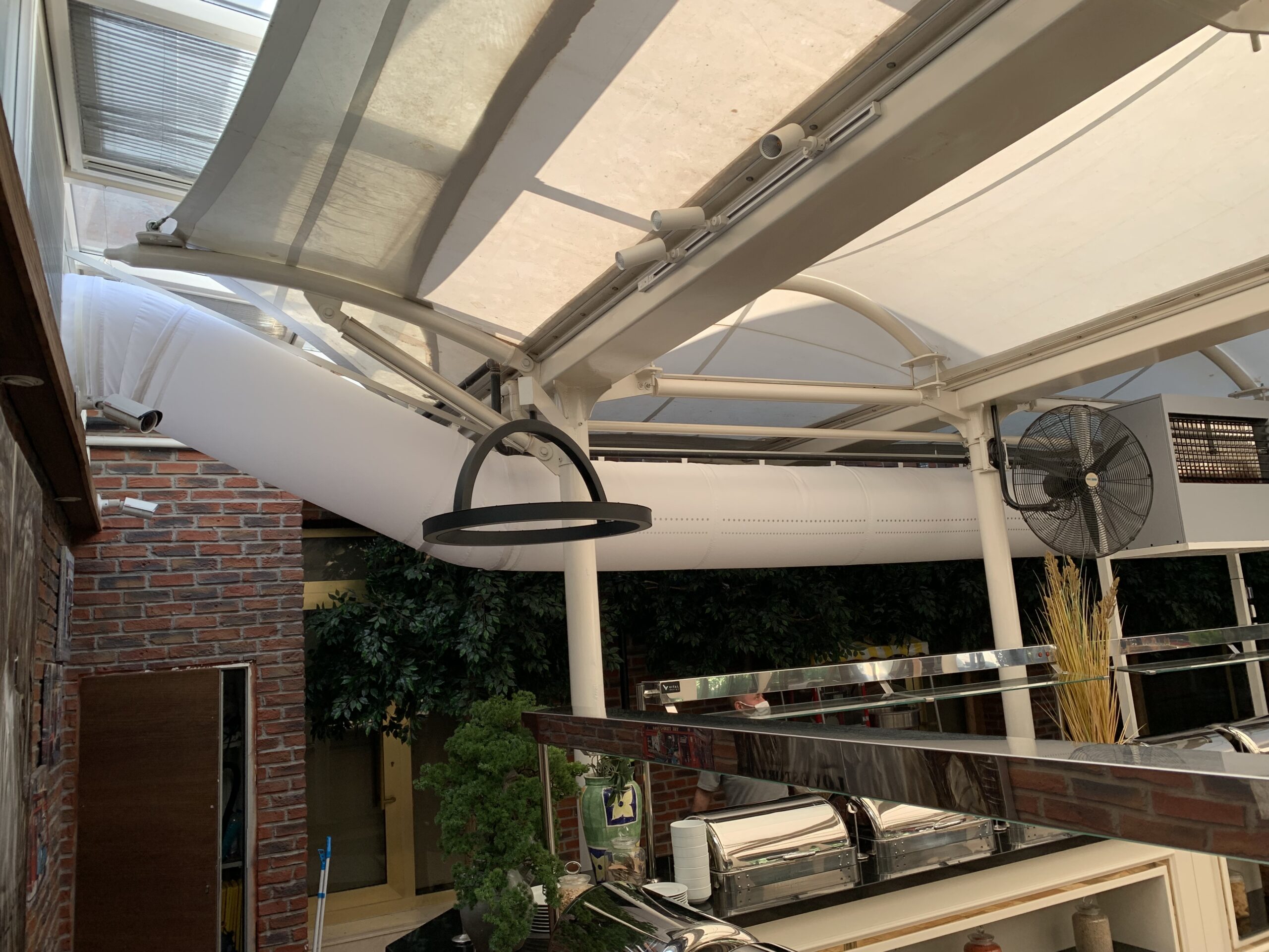 Air duct system with white fabric duct design in an office workspace, UK, 2