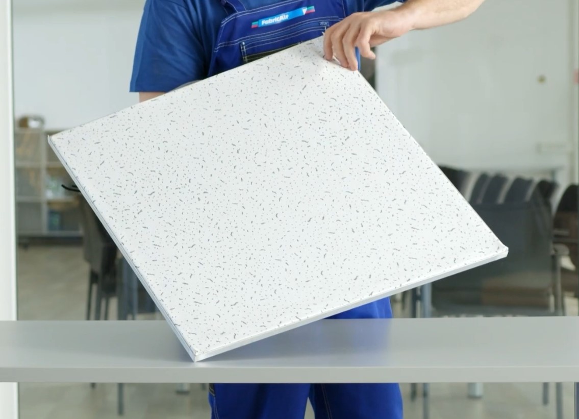 Man holding a ceiling diffuser, UK, 2