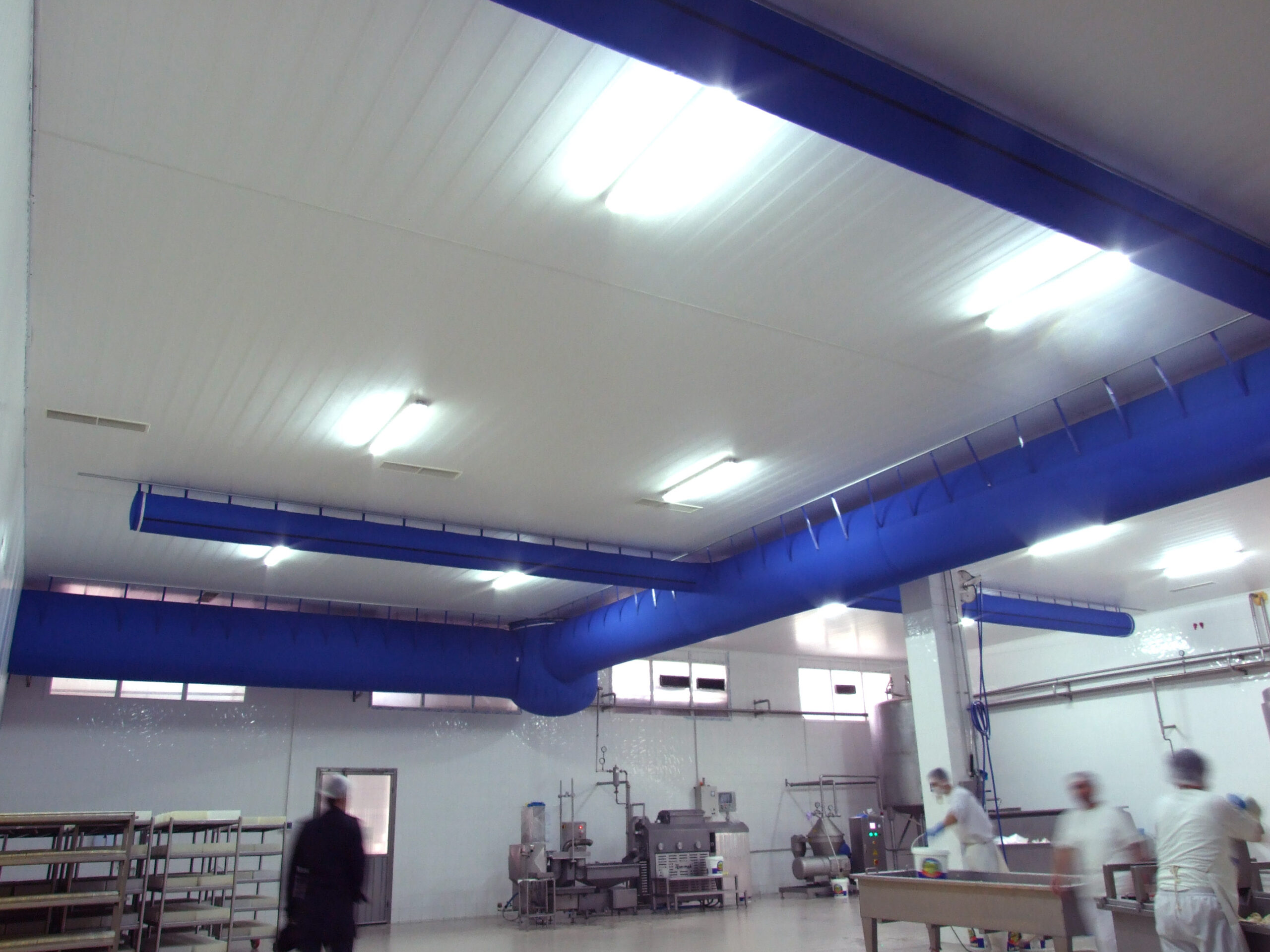 Factory air duct systems with blue fabric ducts installed in İnan Süt, Turkey, 2
