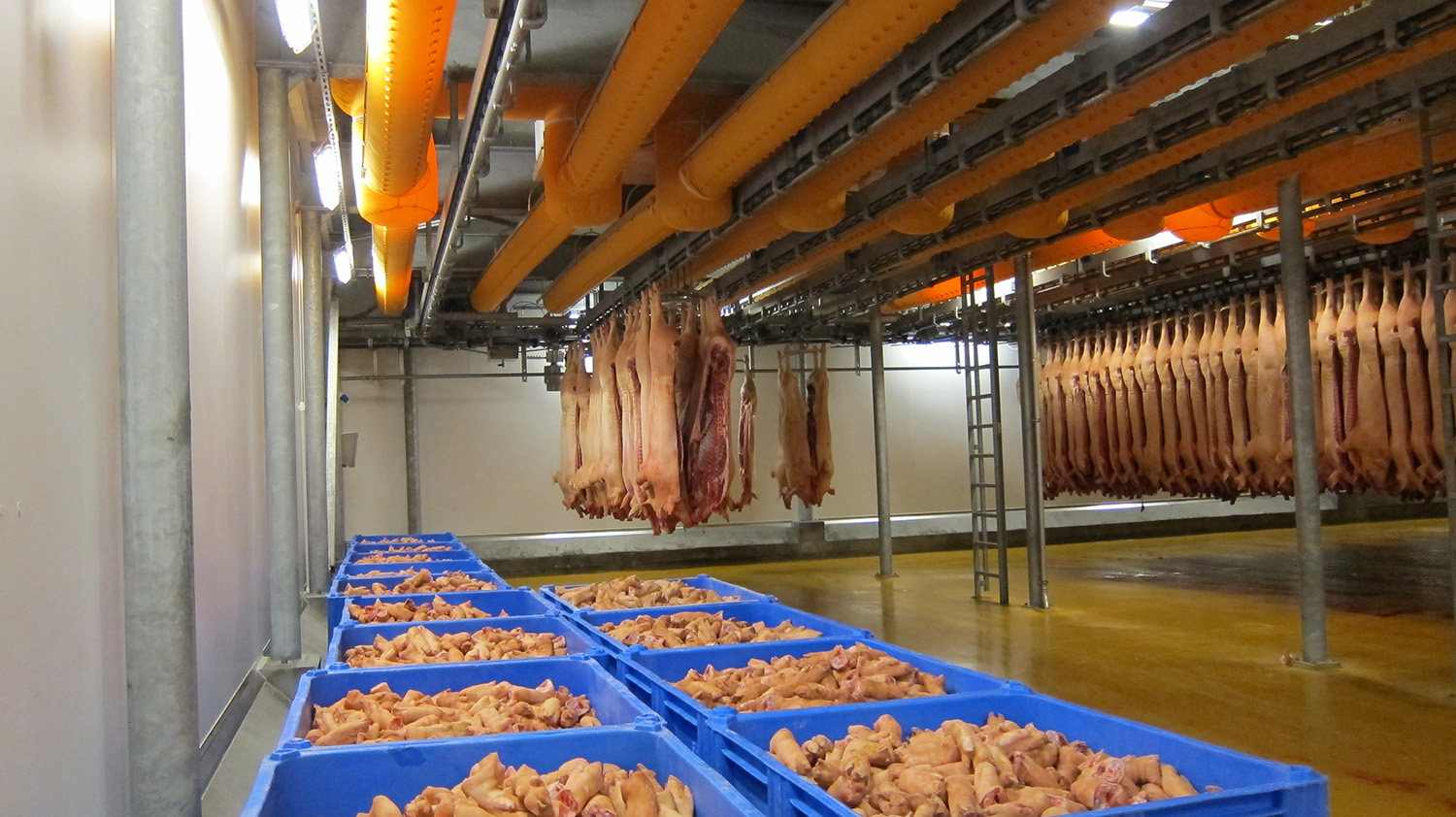 Orange air duct systems installed inside a meat factory, Danish Crown, Denmark, 2