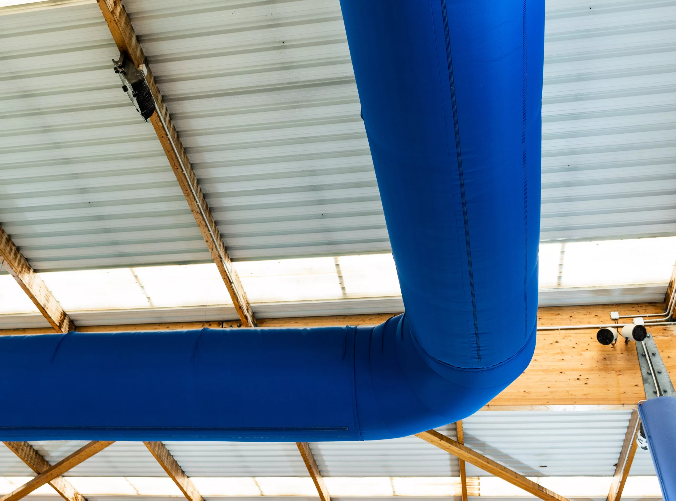 Blue fabric air duct in a swimming pool, UK
