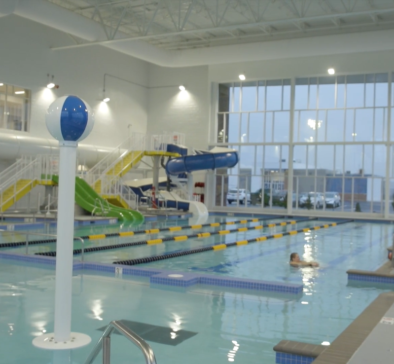 Swimming pool air duct system with white ventilation duct design inside Aquatic Center at Mylan Park, USA