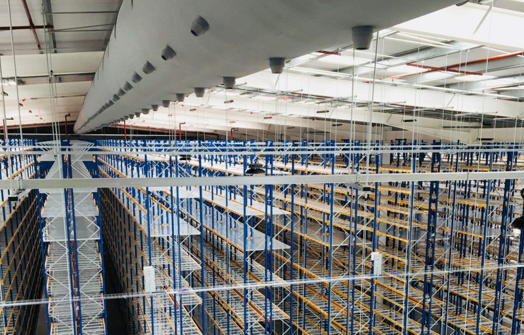 Industrial ductwork system with grey air duct design inside a warehouse, UK