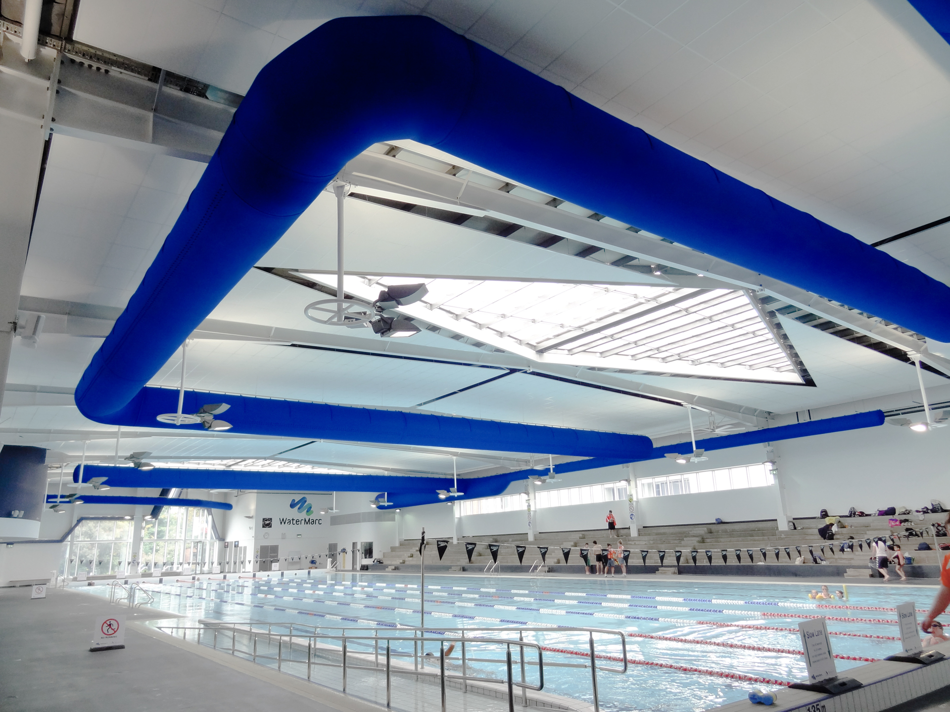 Swimming pool air duct systems with blue air duct design installed inside WaterMarc, Greensborough, Australia