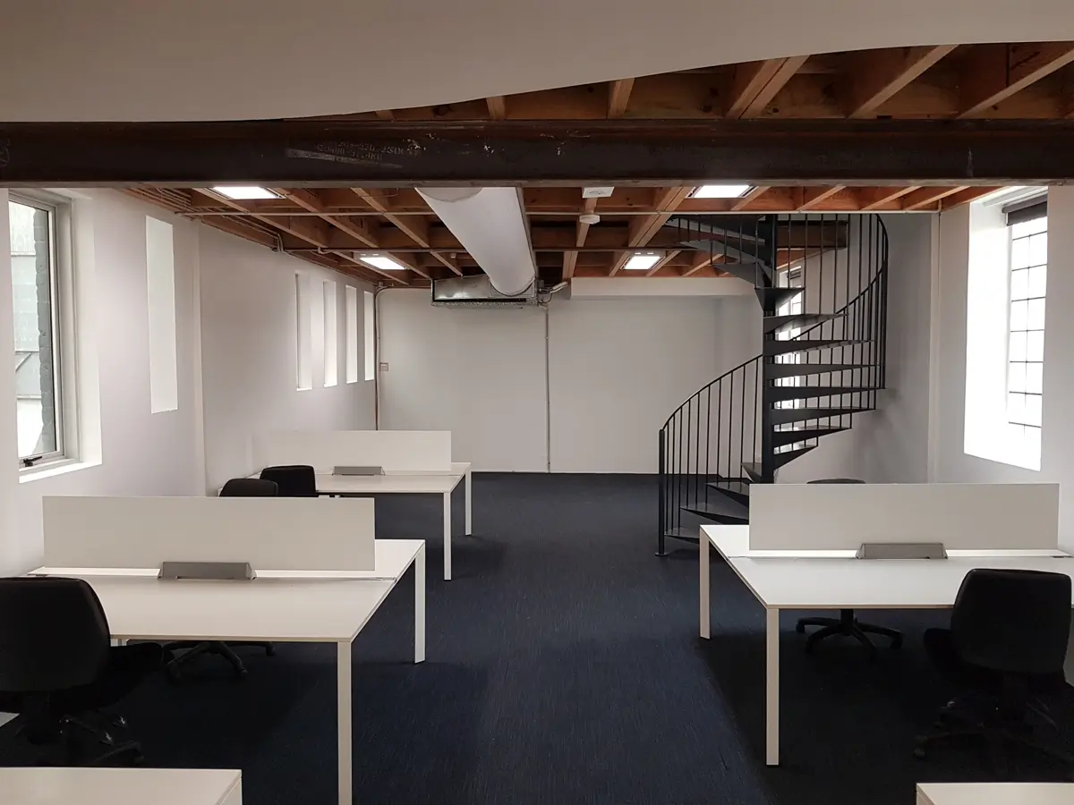Black air duct design in an office workspace, US