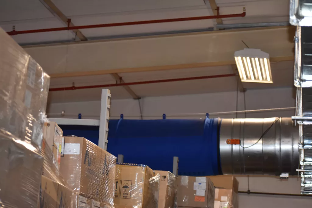 FabricAir’s Varioduct fabric duct solution is showcased in bright blue featuring laser cut holes precisely designed for temperature control that elevates indoor air quality in areas that require heating and cooling solutions.