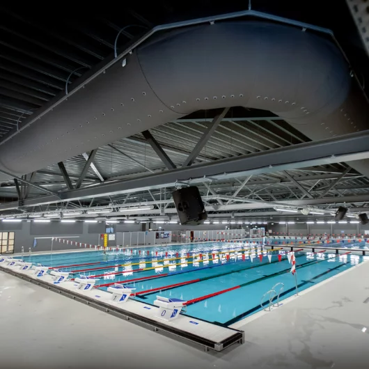 Grey fabric air duct in a swimming pool facility, US