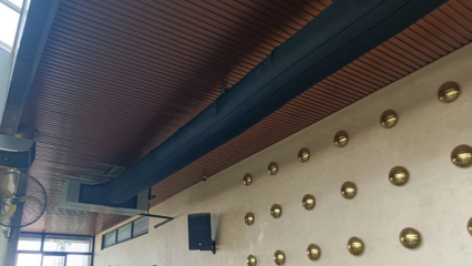 Sleek black fabric duct system provides comfortable, attractive, noiseless airflow for a modern restaurant in India