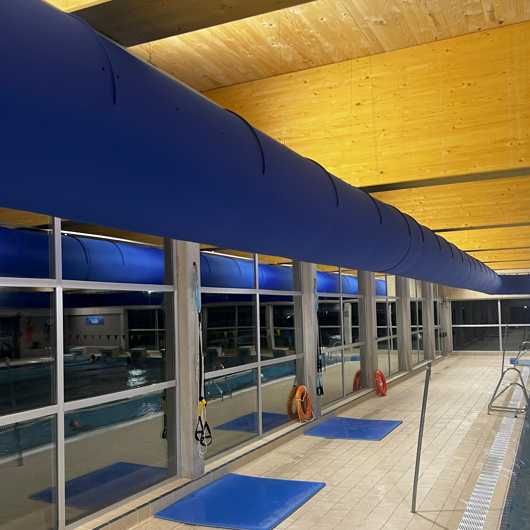 Large blue fabric duct system ensures comfort and high-quality indoor air for an indoor swimming pool in Madrid