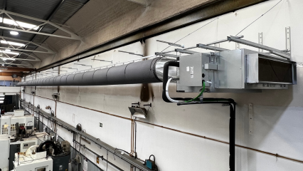 Dark gray fabric air distribution ductwork installed in the MOLMASA manufacturing facility in Barcelona