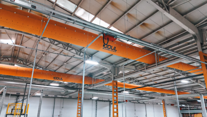 Yellow fabric air ducts with the Odul Solar logo hang in their manufacturing facility