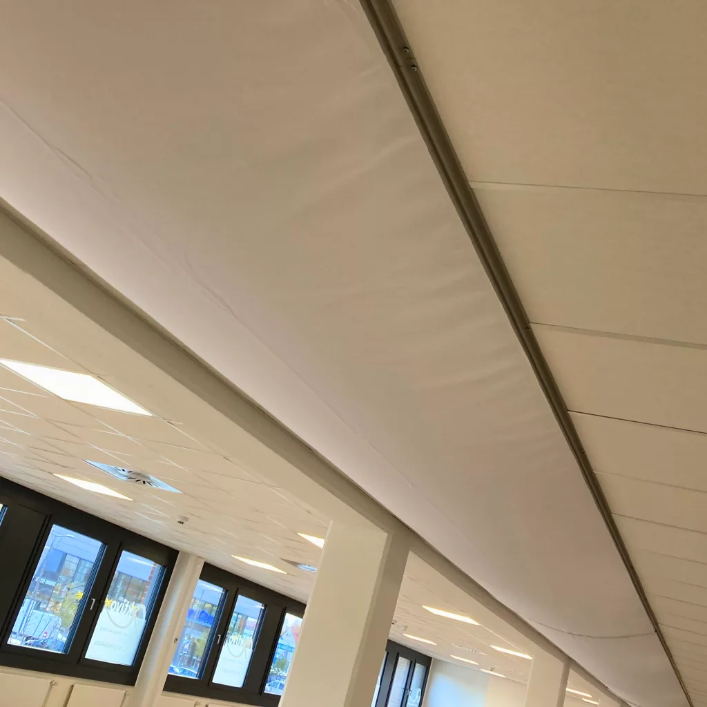 Textile air distribution system utilizing white low profile fabric duct featuring FabricAir’s MicroFlow flow model is installed at a physical therapy office in Braunschweig, Germany to provide a comfortable, draft-free, antimicrobial air dispersion system for employees and patients.