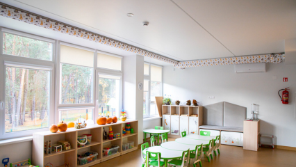 FabricAir ducts with a D-shaped profile and a whimsical woodland animal print are installed in a kindergarten classroom in Kulautuva, Lithuania.