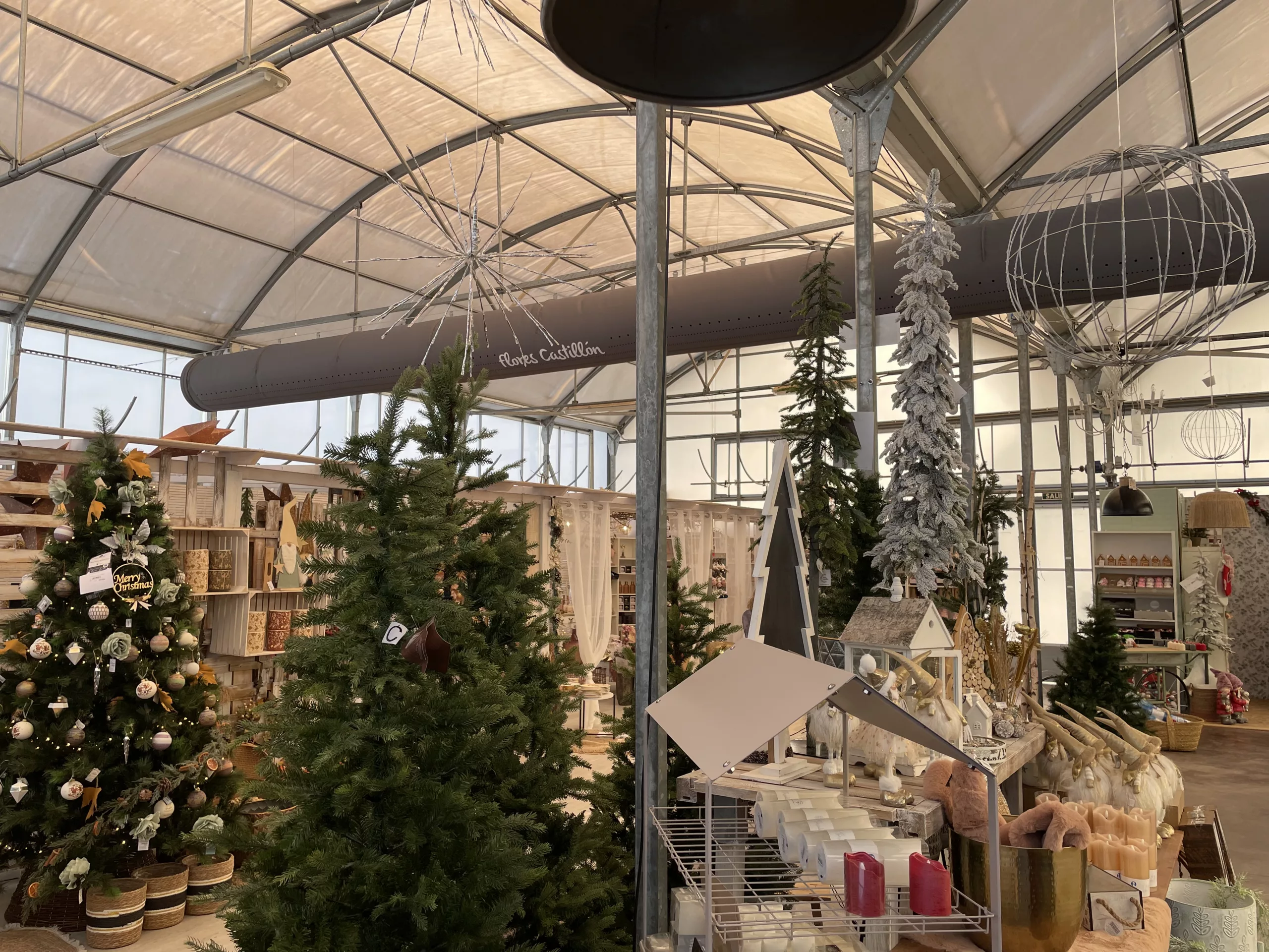 FabricAir ducts in gray fabric featuring custom logos and All-In-One duct shape retention are installed in the Flores Castillon greenhouse and nursery in Barbastro, Spain.