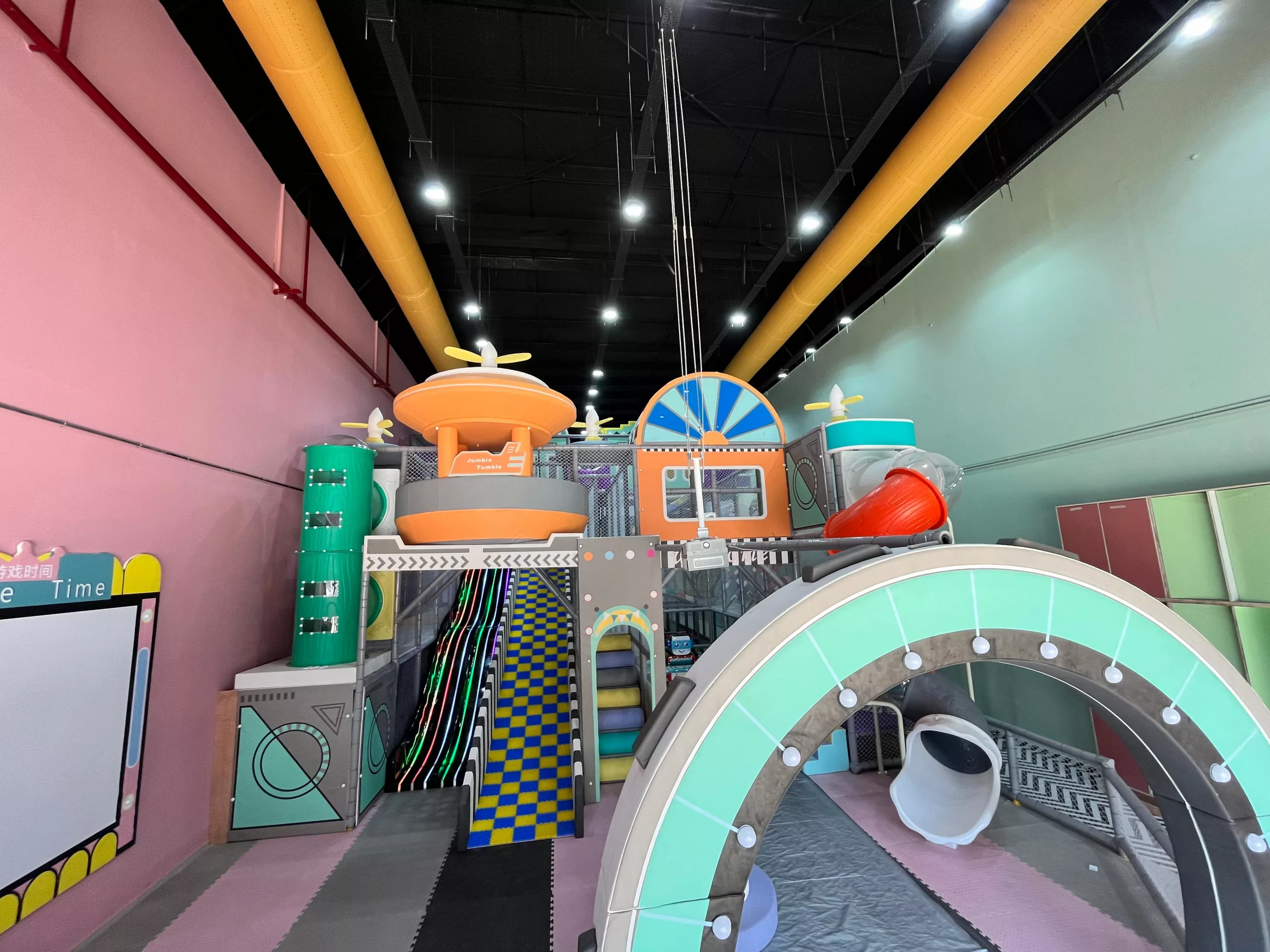 Orange FabricAir ducts provide safe, comfortable airflow for a trampoline park for children in Mumbai.