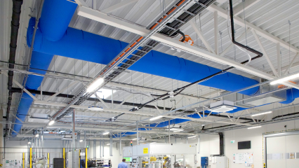 The bright blue fabric duct system installed in the new Axioma Metering factory to provide optimal conditions for sensitive machinery and materials.