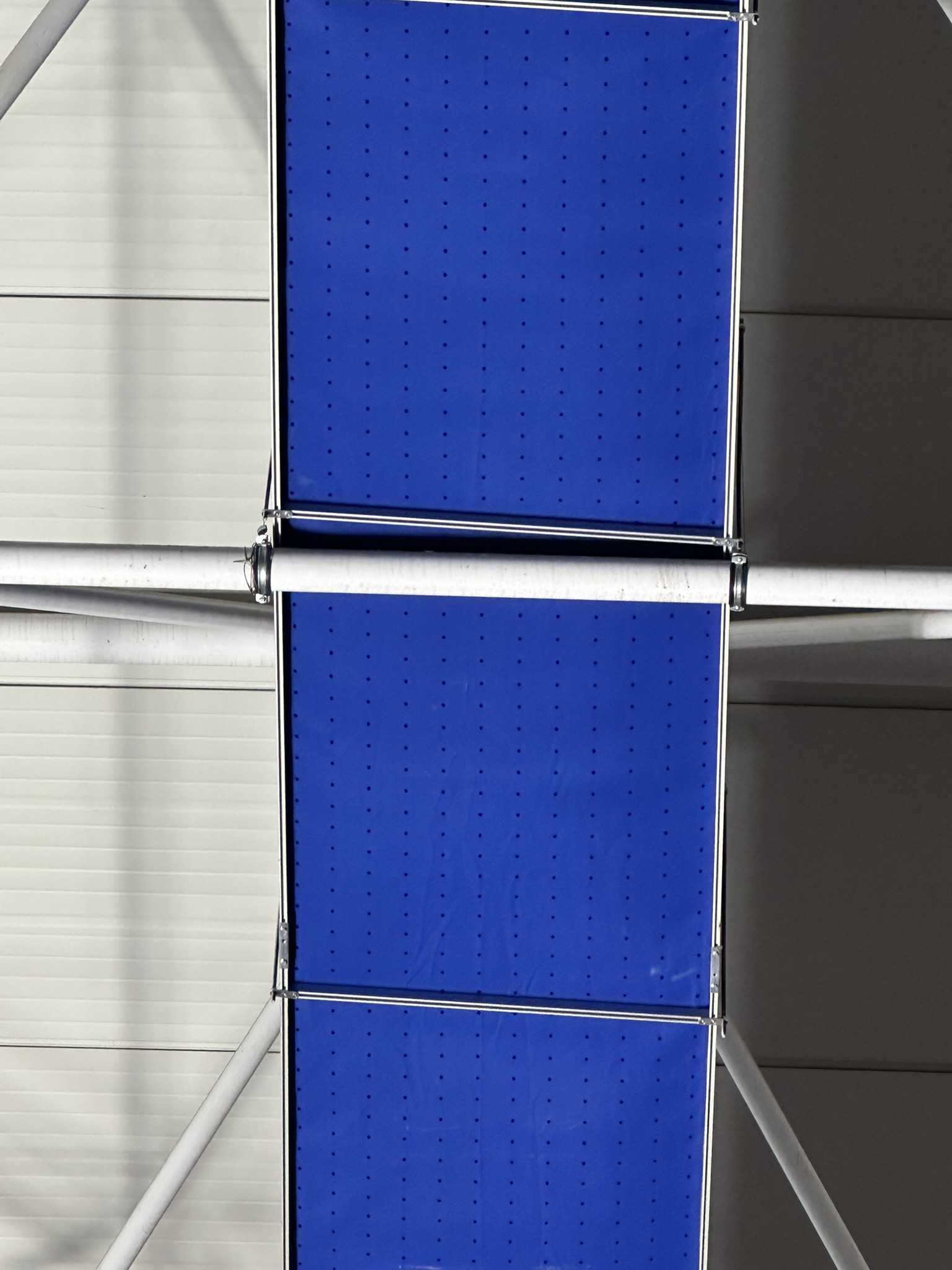 Blue and red fabric ducting provides ventilation and improves air quality in the Gazanfer Bilge Sports Hall in Istanbul